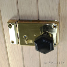 No. 6130 <br />Hexagonal Black Bakelite door knob fitted to a polished brass rim latch. Knob is also available in Mottled Brown