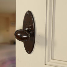 No. 6825 Mottled Brown real Bakelite stepped door knobs with oval back plate. Also available in Black