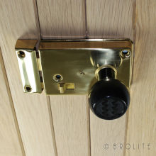 No. 6120 Black <br />Zig Zag Black Bakelite door knob fitted to a polished brass rim latch. Knob is also available in Mottled Brown